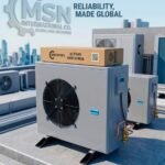 Air-conditioning outdoor units on a rooftop with a cardboard box labeled 'MSN Exports' on top; banner reads 'Reliability, Made Global' in the background.